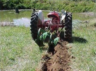 tractor starting to create trench with plow